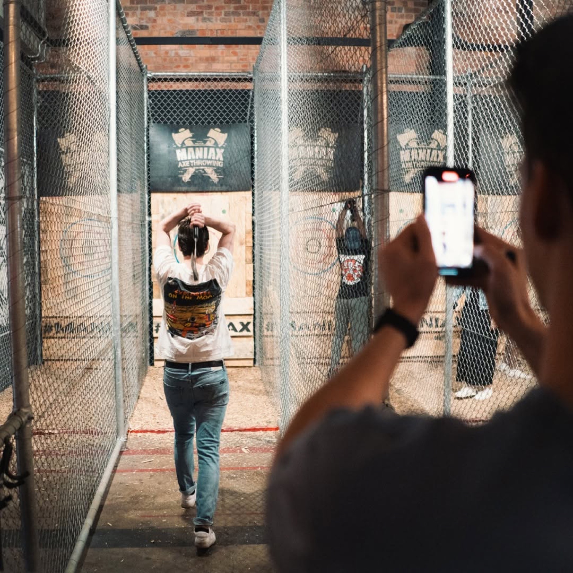 Guests throwing axes in the Maniax cages