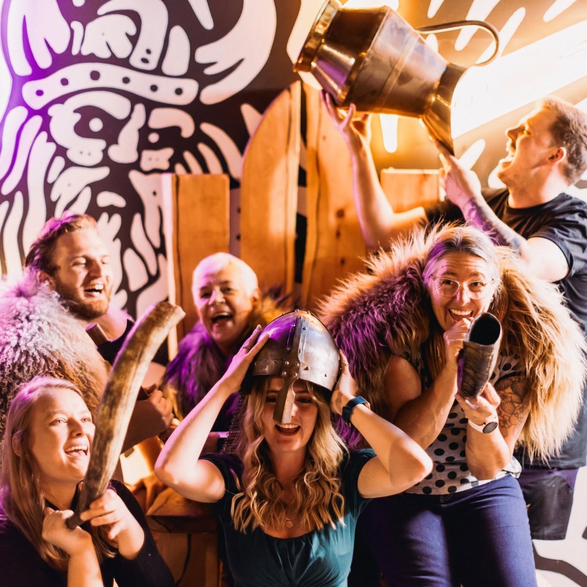 Group celebrating at Maniax Axe Throwing venue launch